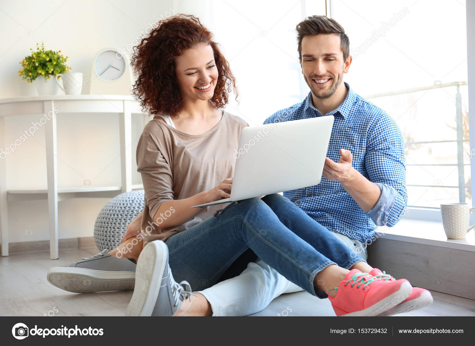 depositphotos-153729432-stock-photo-happy-young-couple-with-laptop